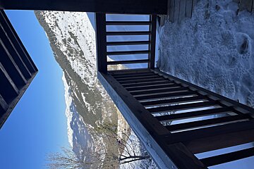 A view of a snowy mountain from a balcony