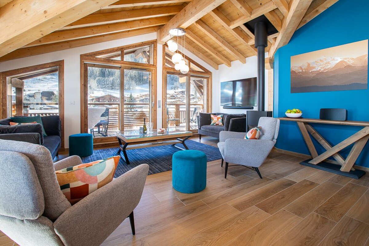 A living room filled with furniture and a blue wall