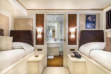 A bedroom with two beds and a picture of betty boop on the wall