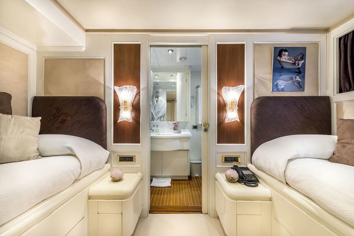 A bedroom with two beds and a picture of betty boop on the wall