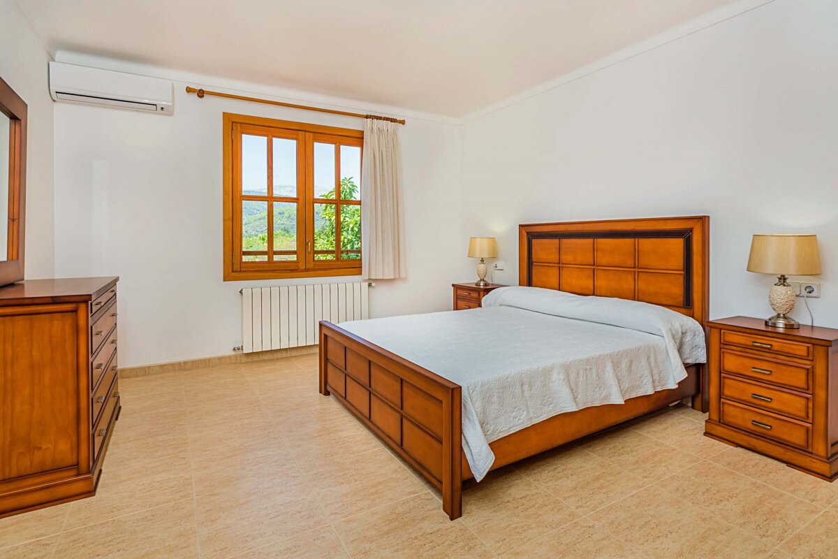 A bedroom with a large bed and two nightstands