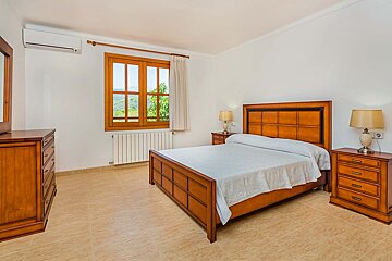 A bedroom with a large bed and two nightstands