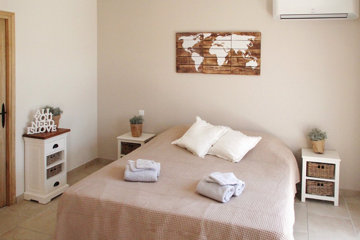 A bedroom with a sign that says all you need is love