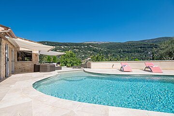 A swimming pool with mountains in the background