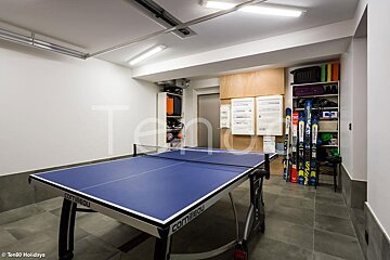 A blue conilleau ping pong table in a garage