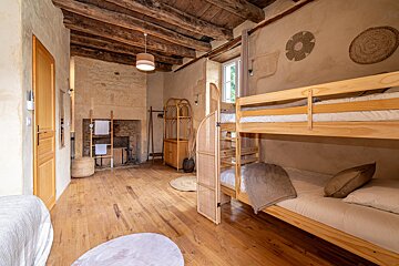 A bedroom with bunk beds and a fireplace