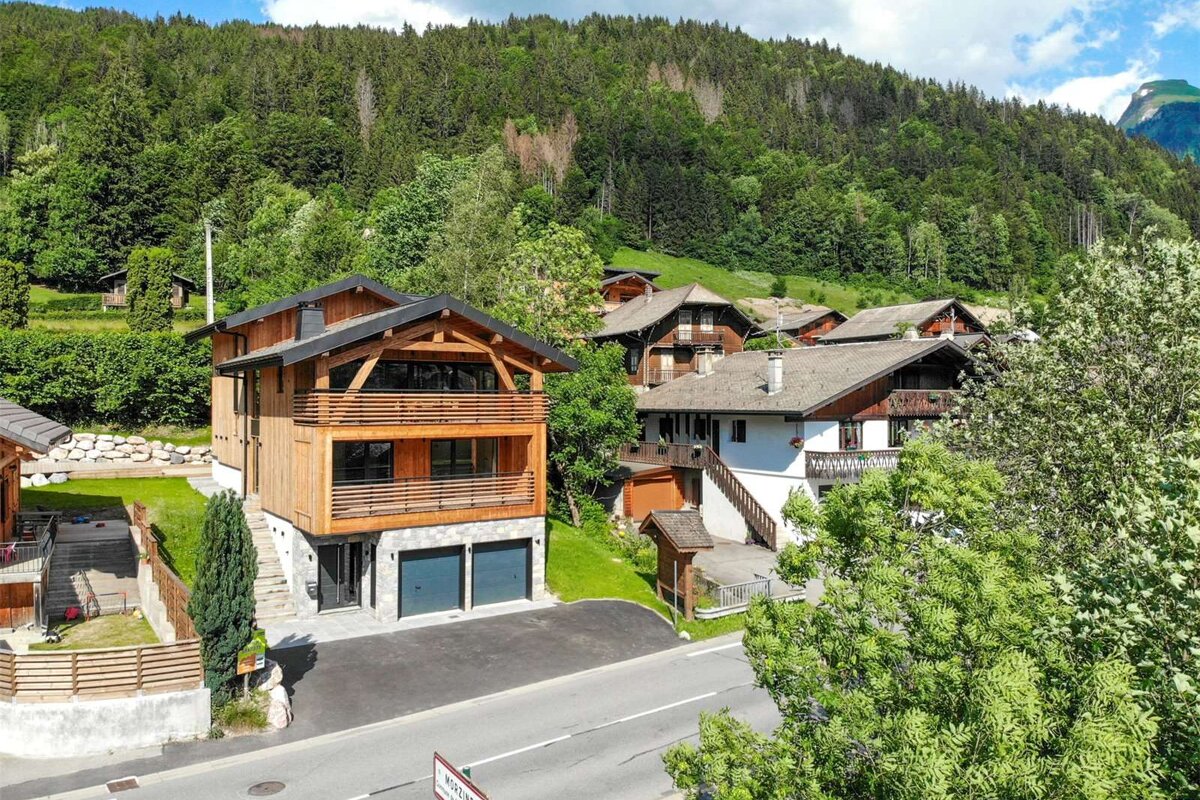 An aerial view of a residential area with mountains in the background
