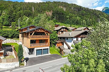 An aerial view of a residential area with mountains in the background