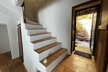 A staircase with a candle on the bottom step