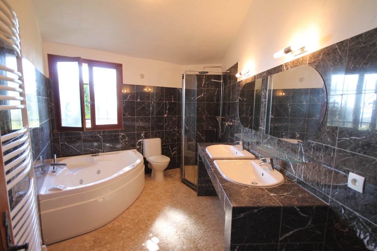 A bathroom with two sinks and a jacuzzi tub