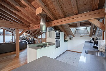 A kitchen with a stove top oven and a sink