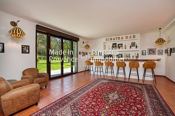 A living room with a sinatra bar in the corner