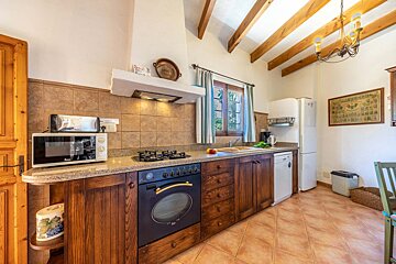 A kitchen with a stove top oven and a microwave