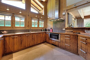 A kitchen with wooden cabinets and stainless steel appliances