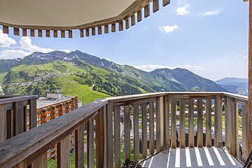 A balcony with a view of a mountain range