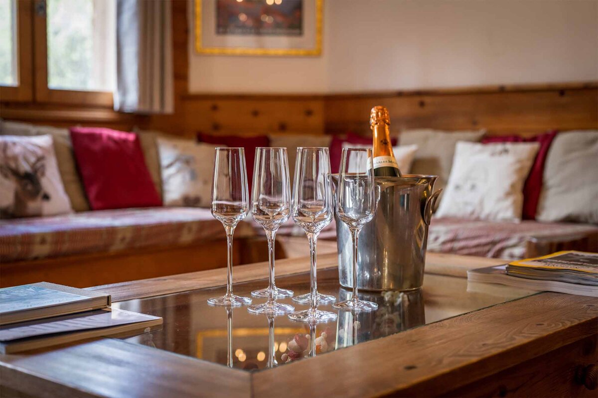 A bottle of champagne sits in an ice bucket on a table
