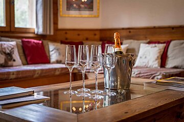 A bottle of champagne sits in an ice bucket on a table