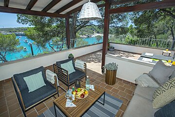 A balcony with a view of a body of water
