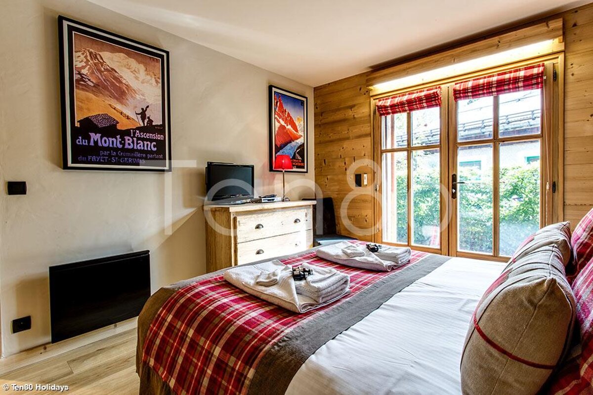 A bedroom with a poster on the wall that says du mont blanc