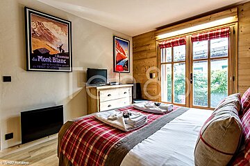 A bedroom with a poster on the wall that says du mont blanc