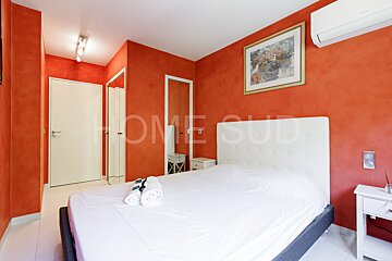 A bedroom with red walls and the word home on the wall