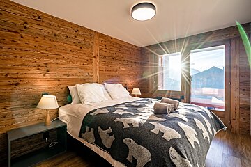 A bed with a polar bear blanket on it