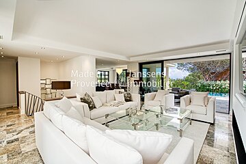 A living room with white furniture and a sign that says made by janssens