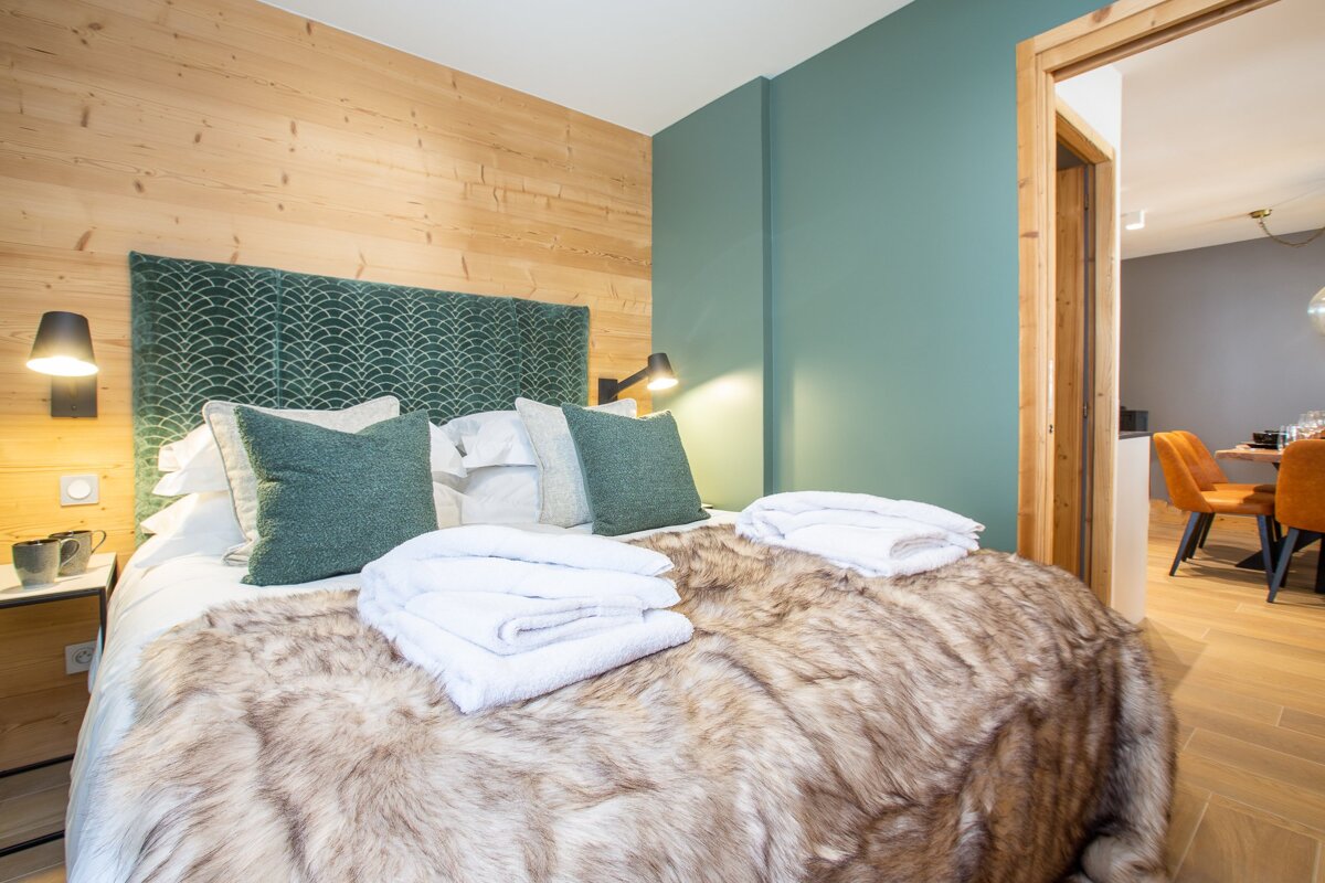 A bedroom with a fur blanket on the bed