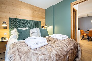 A bedroom with a fur blanket on the bed