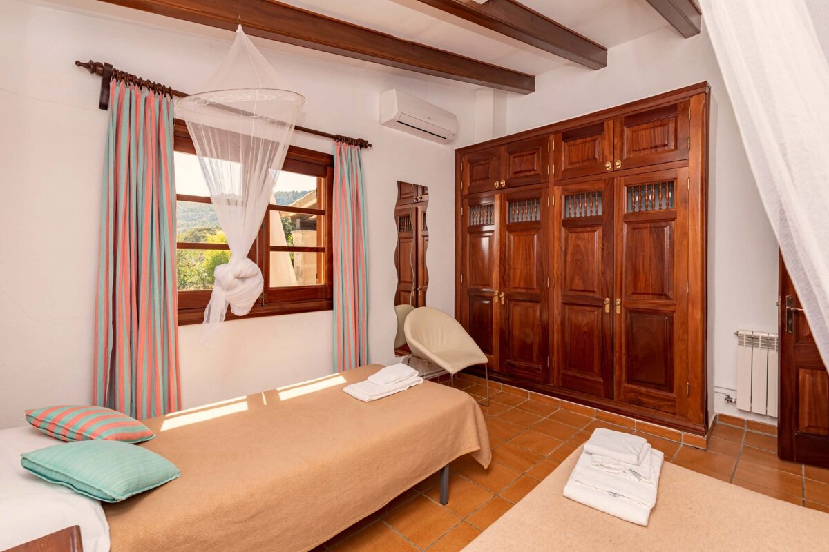 A bedroom with two beds and a large closet