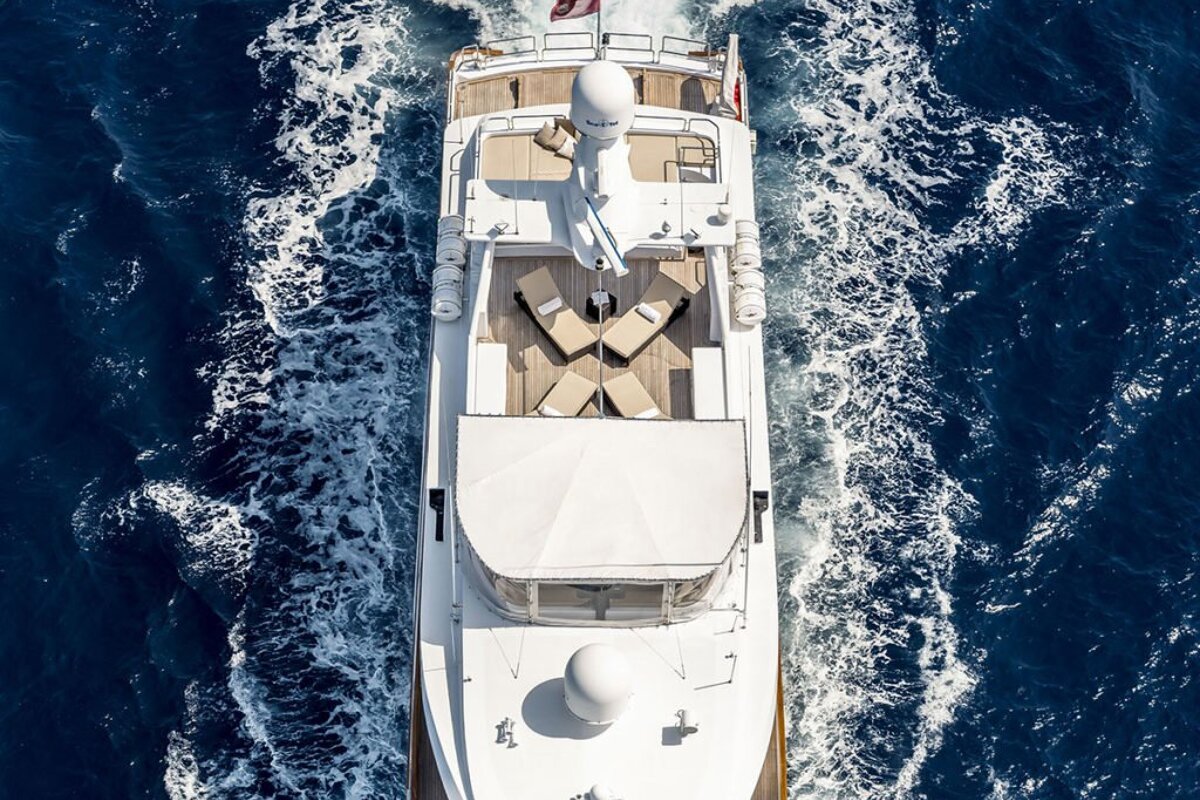An aerial view of a large white yacht floating in the ocean