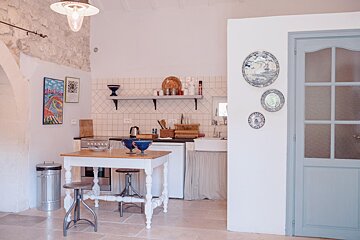 A kitchen with blue and white plates on the wall