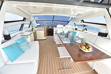 The inside of a boat with a table and couch