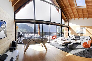 A living room with a foosball table and a couch