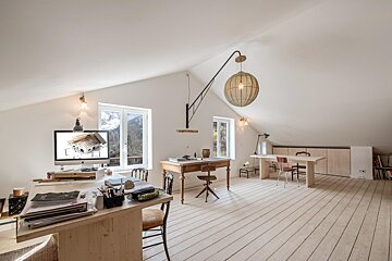 A room with a desk and chairs and a computer monitor that says ' architectural ' on it