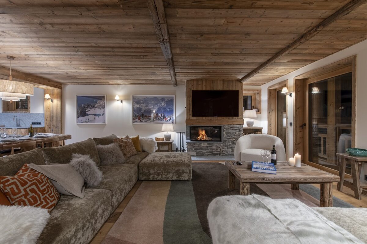 A living room with a couch a chair and a fireplace