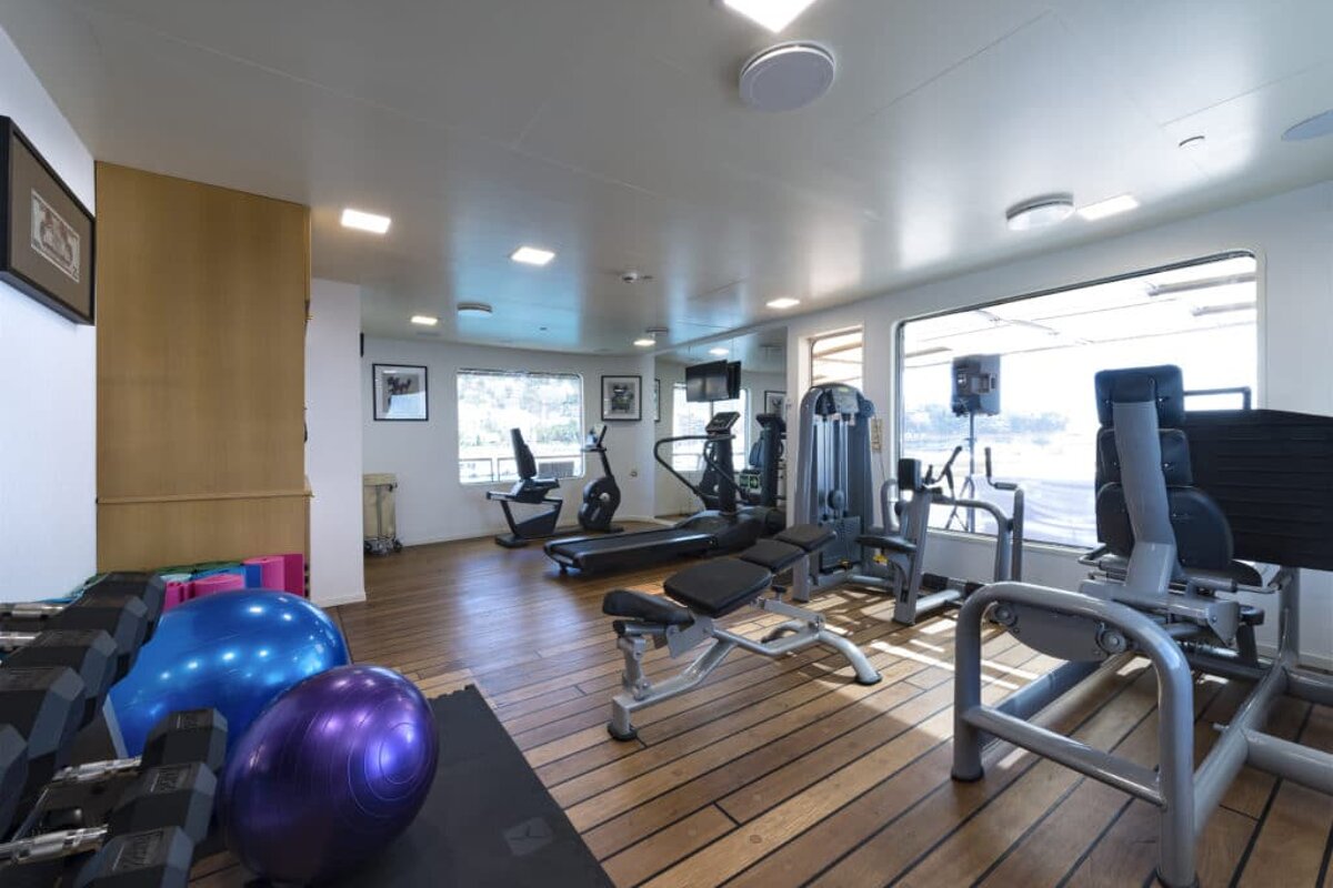 A gym with a purple ball that says ' pilates ' on it