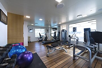 A gym with a purple ball that says ' pilates ' on it