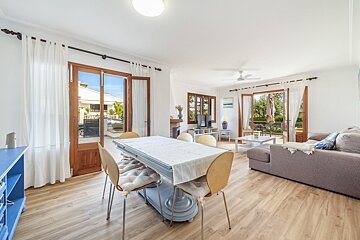 A living room with a table and chairs and a couch