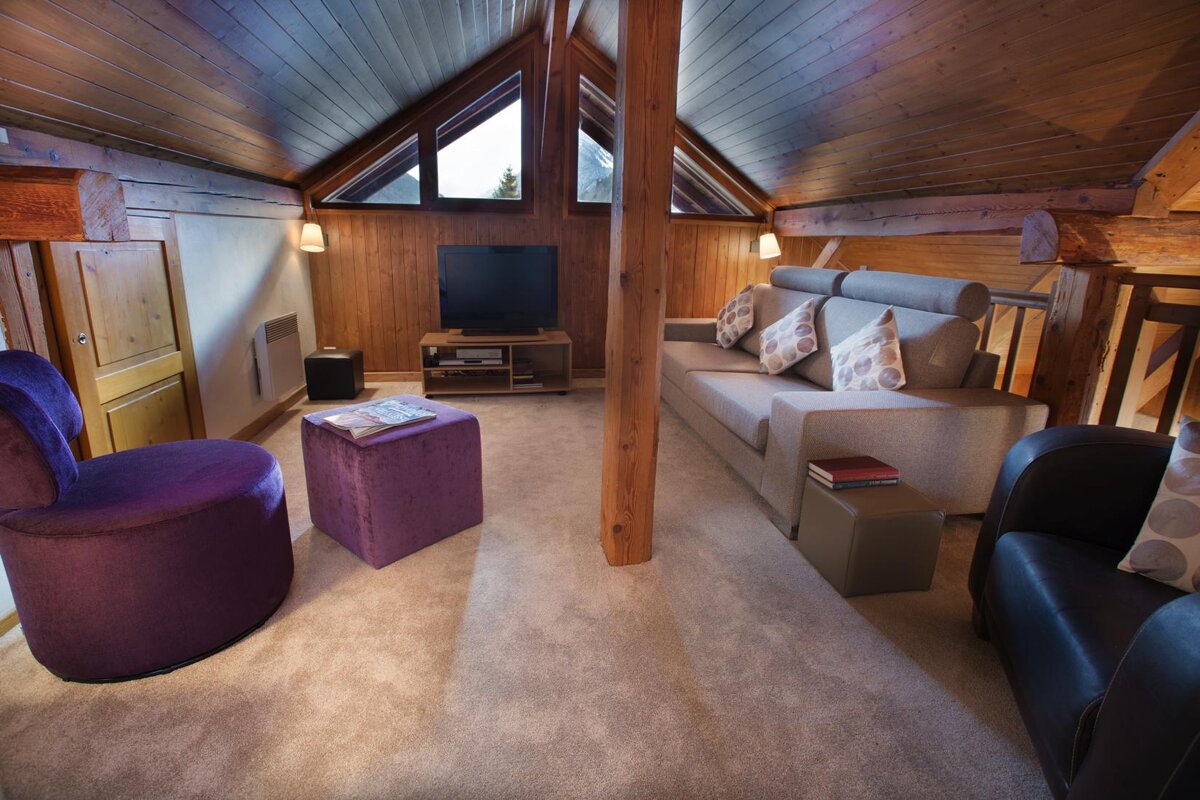A living room with a couch a chair and a television