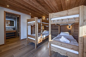 A bedroom with bunk beds and a bathroom