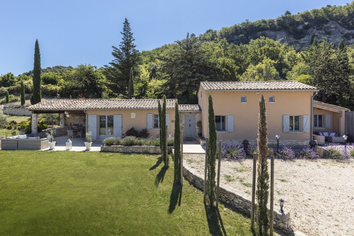A house with a large lawn in front of it