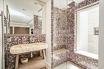 A bathroom with a sink and a shower with the words maison provence written on the wall