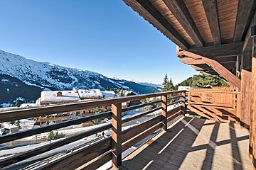 A balcony with a view of snow covered mountains
