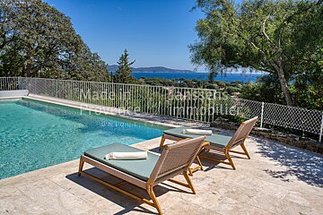 A swimming pool is surrounded by a fence with the words made in france written on it