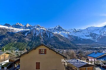 Mountain base immobilier real estate is written on the side of a building