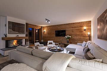 A living room with a couch and chairs and a fireplace