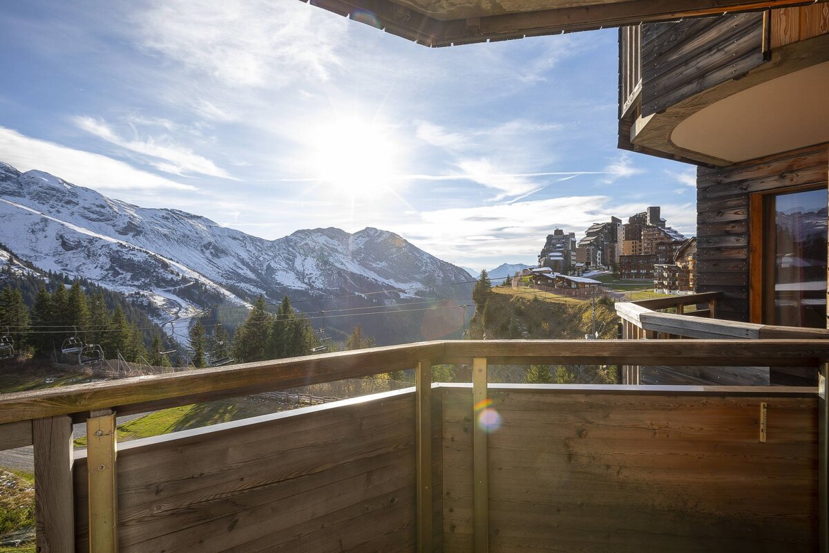 A balcony with a view of snowy mountains