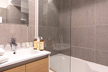 A bathroom with two bottles of nivea on the sink