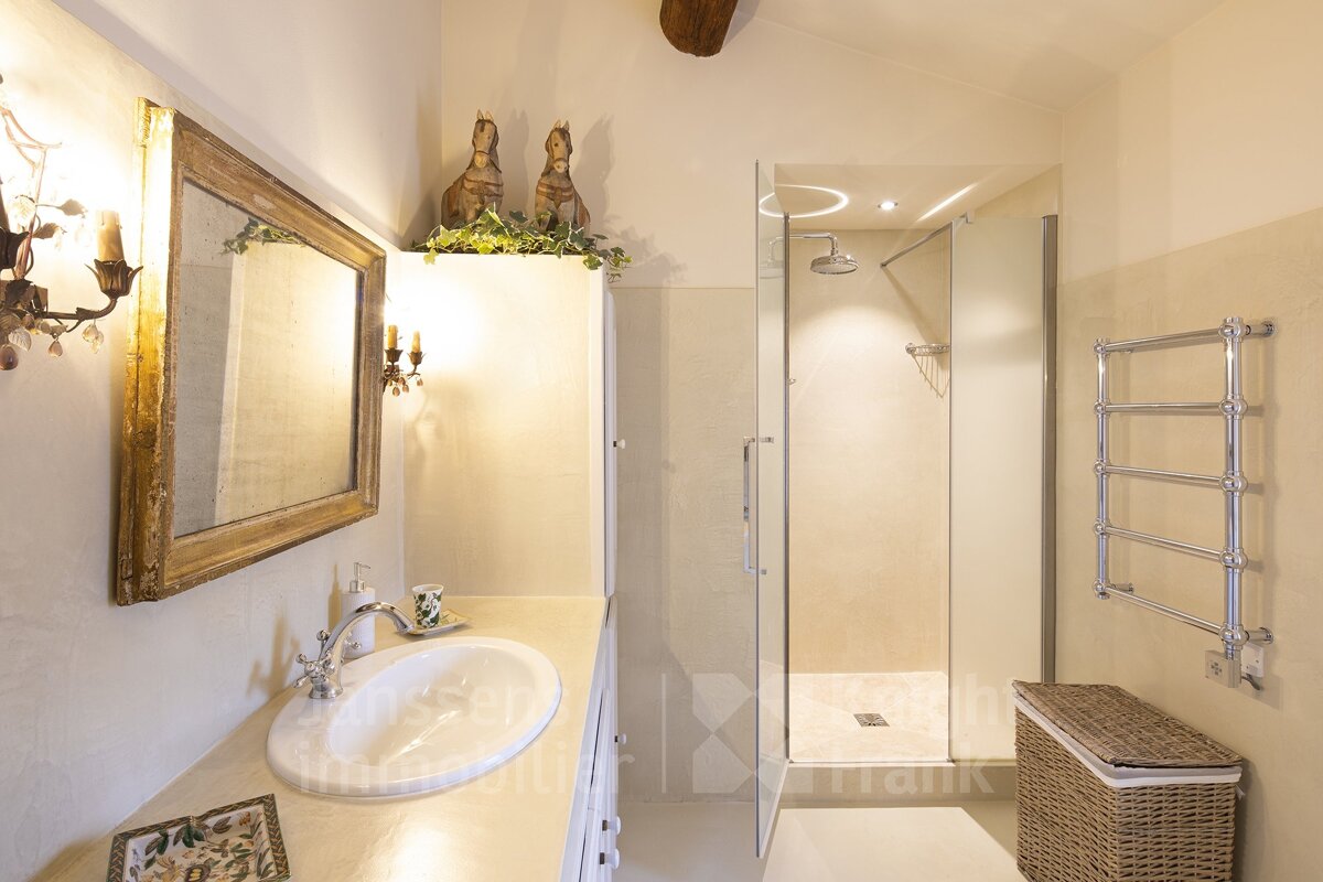 A bathroom with a sink and a walk in shower